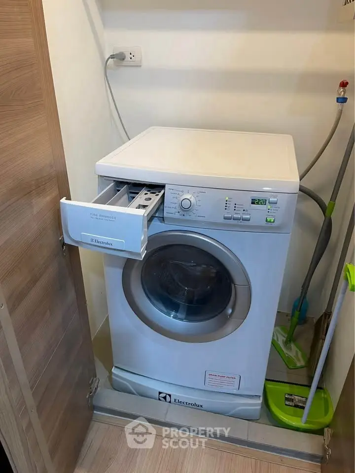 Compact laundry area with Electrolux washing machine in modern home