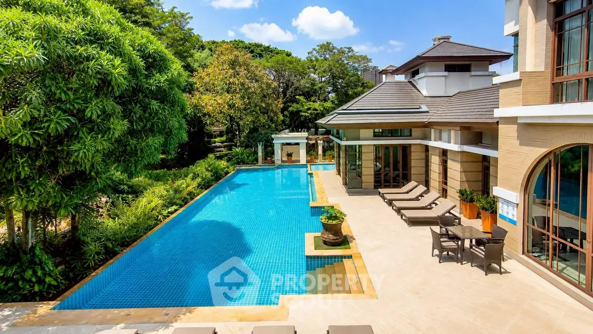 Luxurious villa with stunning pool and lush garden, perfect for relaxation and entertainment.
