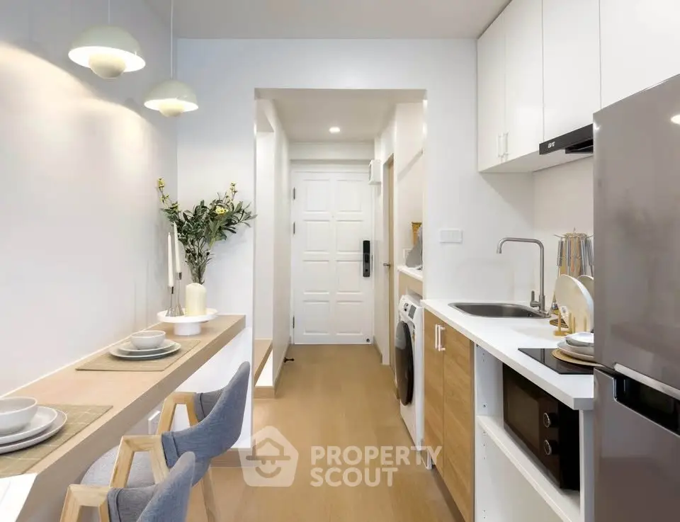 Modern kitchen with sleek appliances and cozy dining area