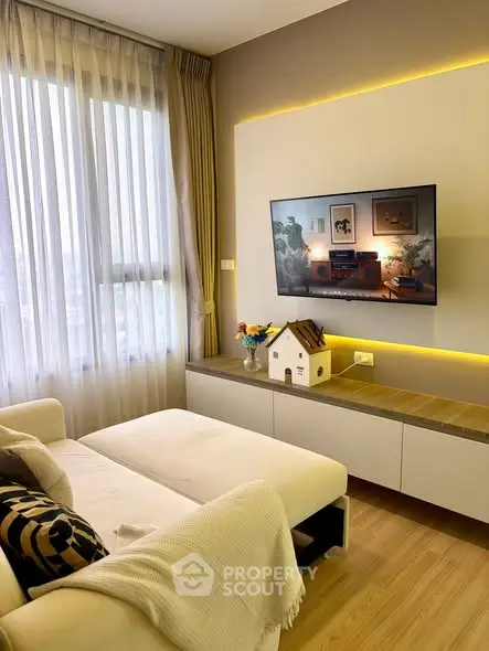 Modern living room with wall-mounted TV and cozy decor
