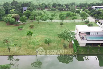 Luxurious riverside villa with lush green garden and scenic views