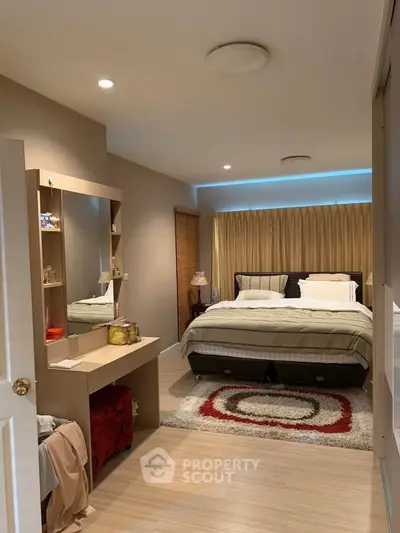Spacious bedroom with modern decor and cozy ambiance