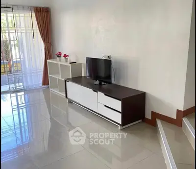 Spacious living room with modern TV stand and glossy tiled floor