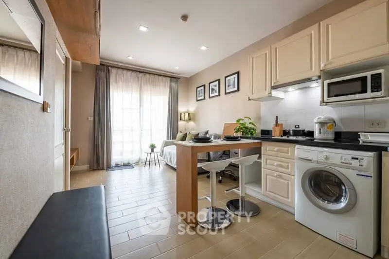 Modern studio apartment with open kitchen and washing machine