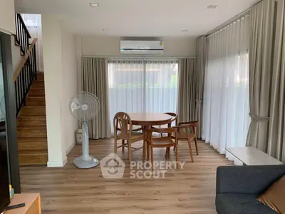 Spacious living room with wooden dining set and modern decor