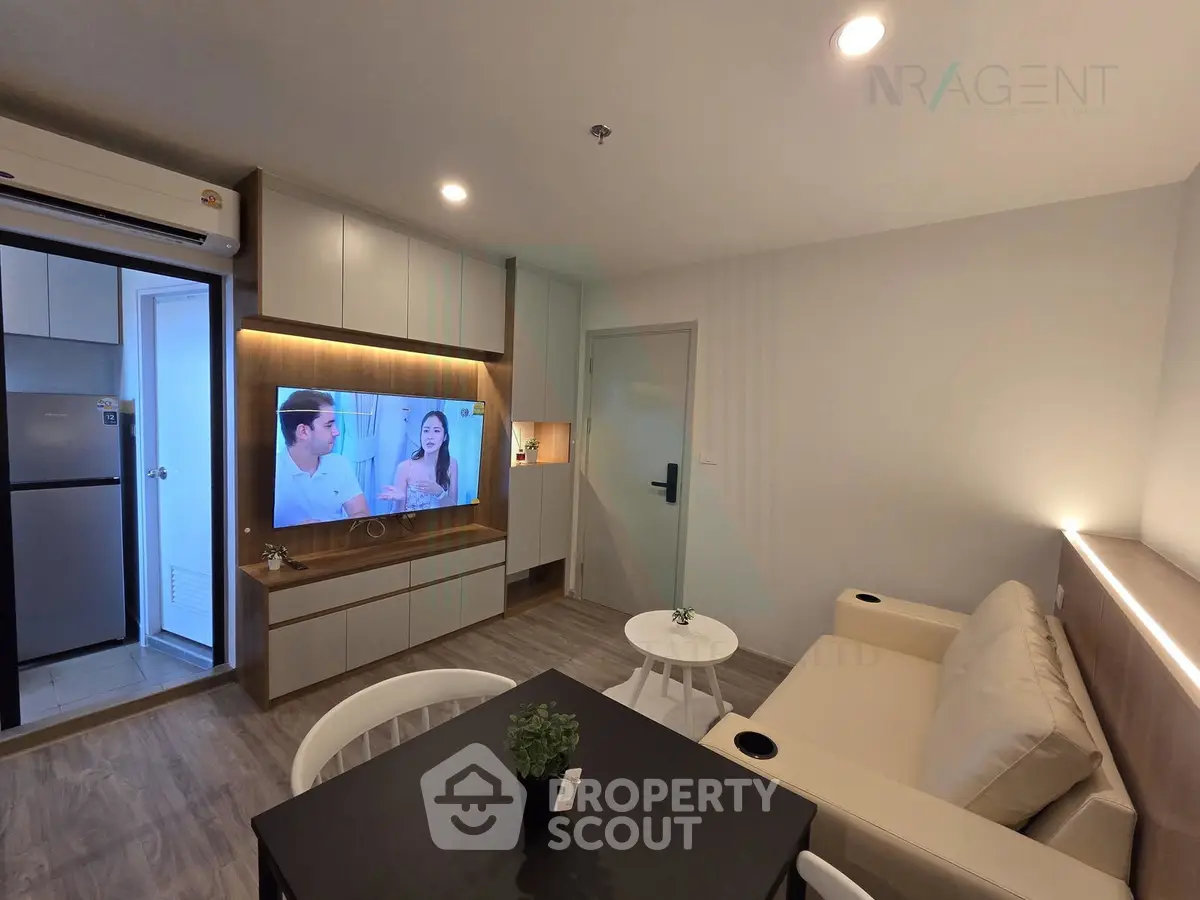Modern living room with built-in TV unit and cozy seating area