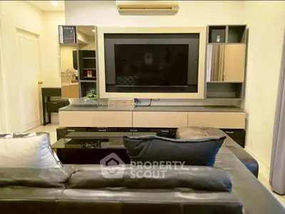 Stylish living room with modern entertainment center and cozy seating.