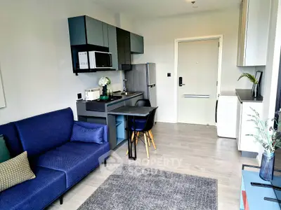 Modern studio apartment with sleek kitchen and cozy living area