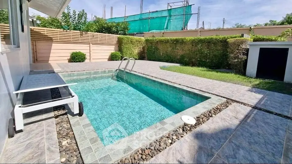 Charming backyard with private pool and lush greenery, perfect for relaxation and entertainment.