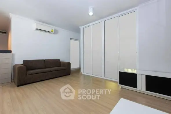 Spacious living room with modern sofa and ample storage space