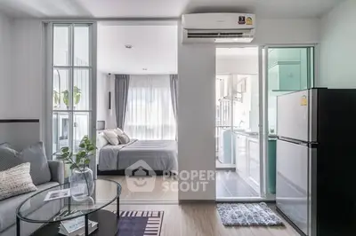 Modern open-plan apartment with cozy living area and sleek kitchen