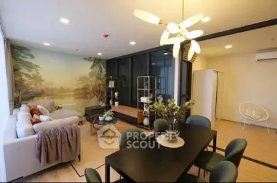Spacious modern living room with elegant decor and dining area, featuring large windows and stylish lighting.