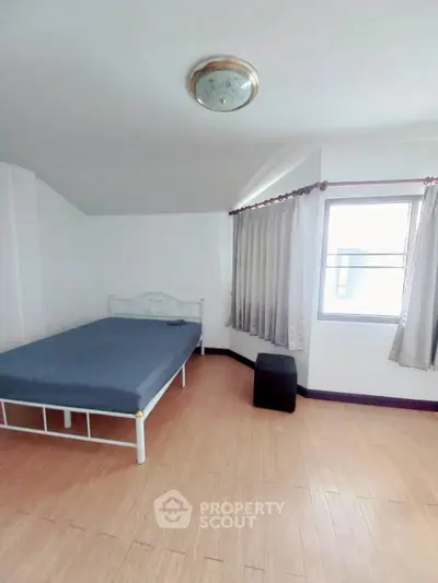 Spacious bedroom with natural light and minimalist decor