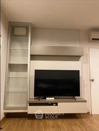 Modern living room with sleek TV unit and glass display cabinet