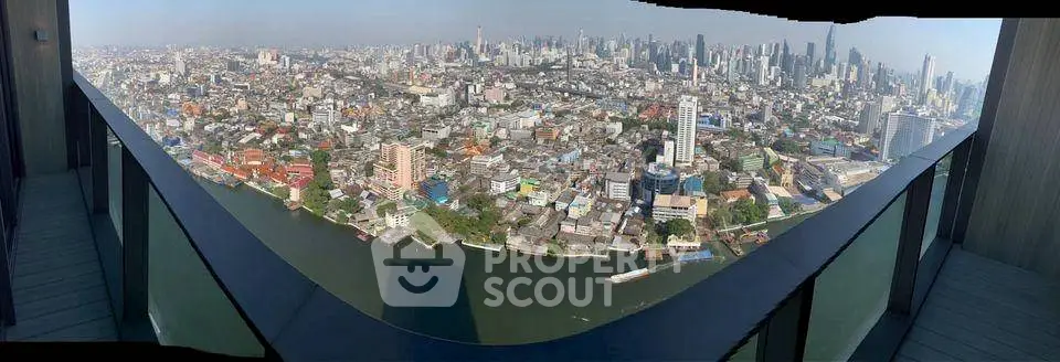 Stunning panoramic city view from a high-rise balcony overlooking a river, perfect for urban living enthusiasts.