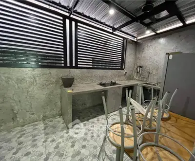 Modern industrial kitchen with concrete countertops and gas stove