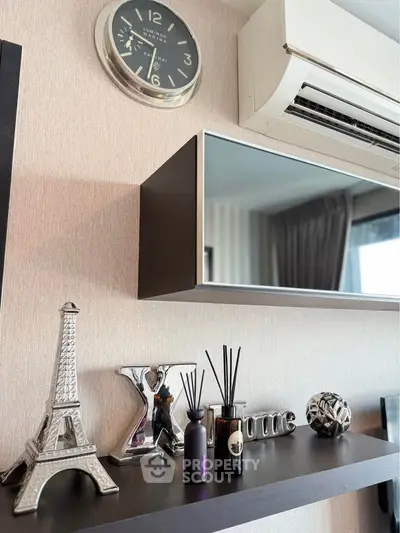 Stylish living room decor with wall clock and air conditioning unit