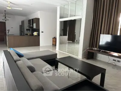 Spacious modern living room with sleek furniture and open kitchen layout