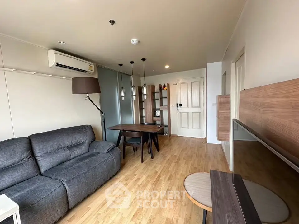 Modern living room with stylish furniture and wooden flooring in a cozy apartment.