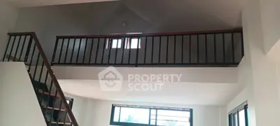 Spacious modern interior with high ceilings and mezzanine level, perfect for stylish living.