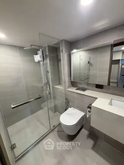 Modern bathroom with glass shower and sleek fixtures
