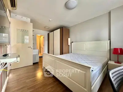 Spacious bedroom with modern furnishings and ample natural light