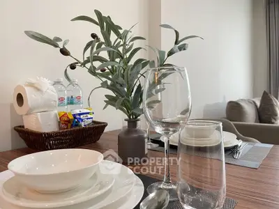 Elegant dining setup with modern tableware and cozy living room ambiance.