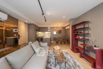 Modern living room with open kitchen, stylish decor, and elegant lighting in a contemporary apartment.