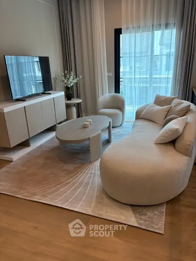 Elegant living room with modern furniture and large window view