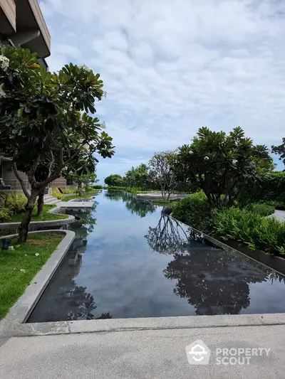 Luxurious garden view with serene water feature and lush greenery