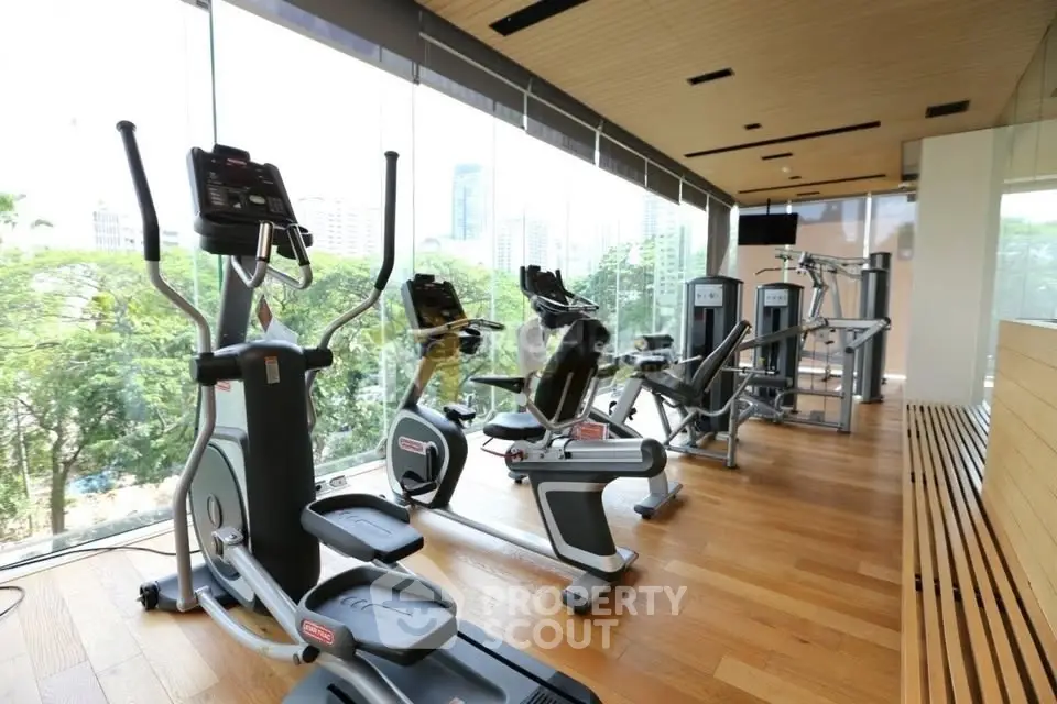 Modern gym with state-of-the-art equipment and scenic city views.