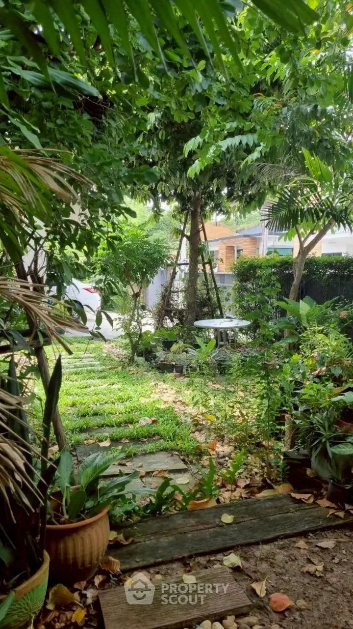 Lush garden view with vibrant greenery and cozy outdoor seating area, perfect for relaxation and nature lovers.