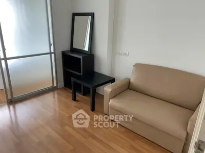 Modern minimalist living room with beige sofa and sleek wooden flooring