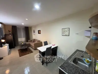 Spacious open-plan living room with modern kitchen and cozy seating area.