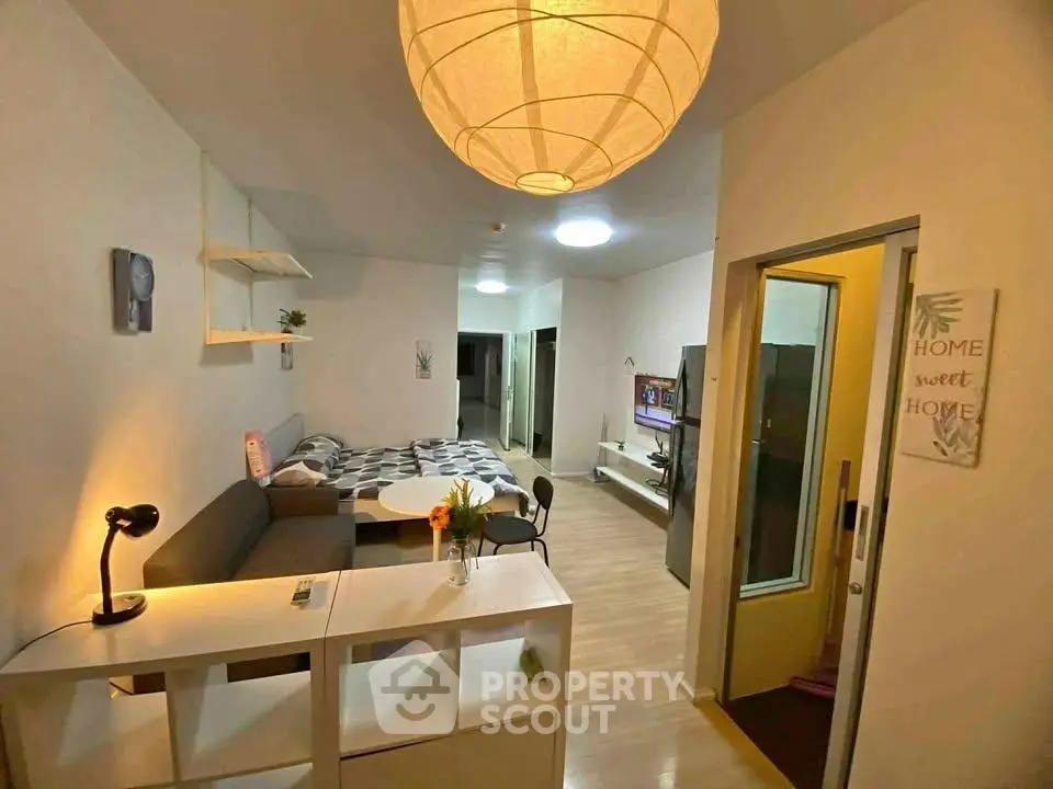 Cozy studio apartment with modern decor and open layout, featuring a comfortable living area and stylish lighting.