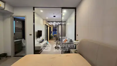 Modern apartment interior with open layout, featuring a cozy living room and stylish bedroom.