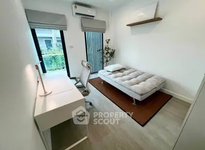 Modern minimalist bedroom with sleek desk and cozy bed, perfect for urban living.