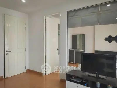 Modern living room with sleek TV stand and wooden flooring