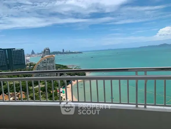 Stunning ocean view from high-rise balcony overlooking turquoise waters and city skyline.