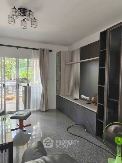 Spacious living room with modern decor and large windows for natural light.