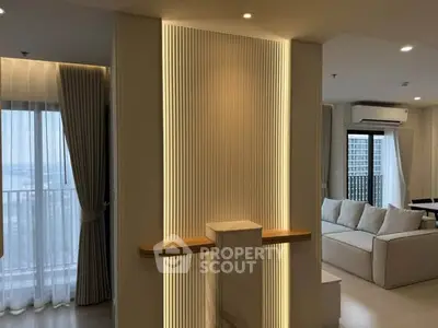 Modern living room with elegant lighting and large windows offering a stunning view.