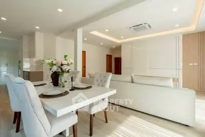 Spacious modern living and dining area with elegant decor and natural light.