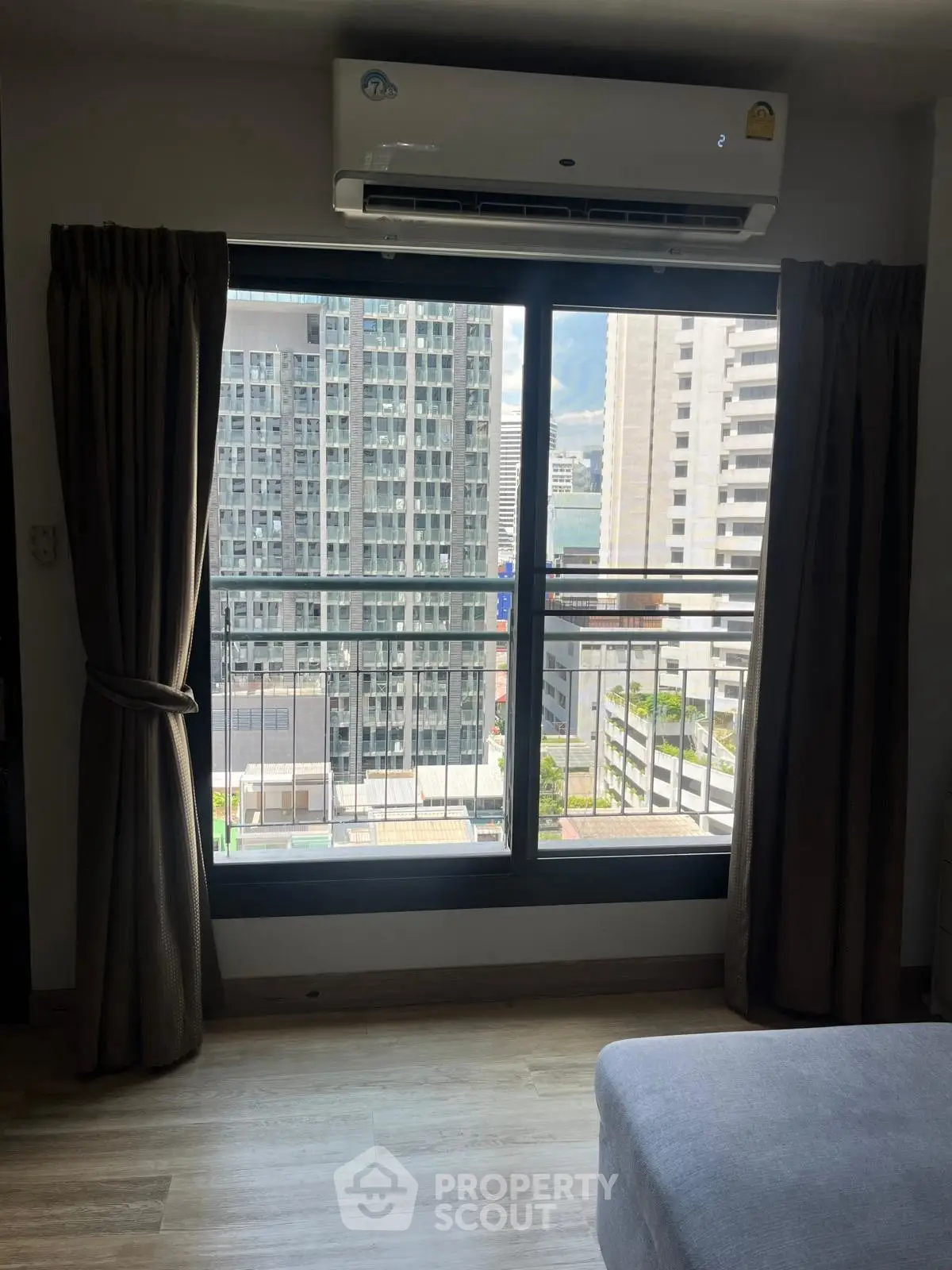 Modern apartment bedroom with city view and air conditioning