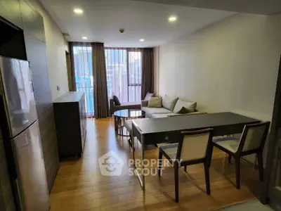 Modern living room with wooden flooring and stylish furniture in a cozy apartment setting.