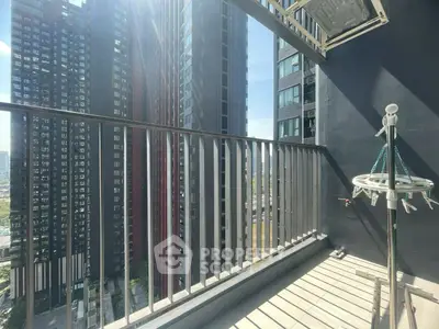 Modern urban balcony with city skyscraper view and ample sunlight.