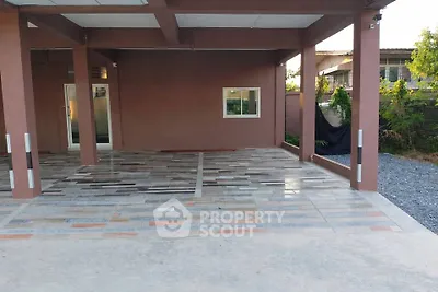 Spacious modern carport with stylish tiled flooring and covered roof, perfect for multiple vehicles.