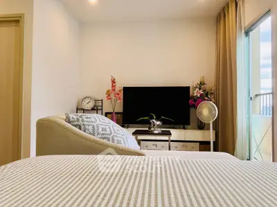 Modern bedroom with stylish decor and balcony view in a luxurious apartment.