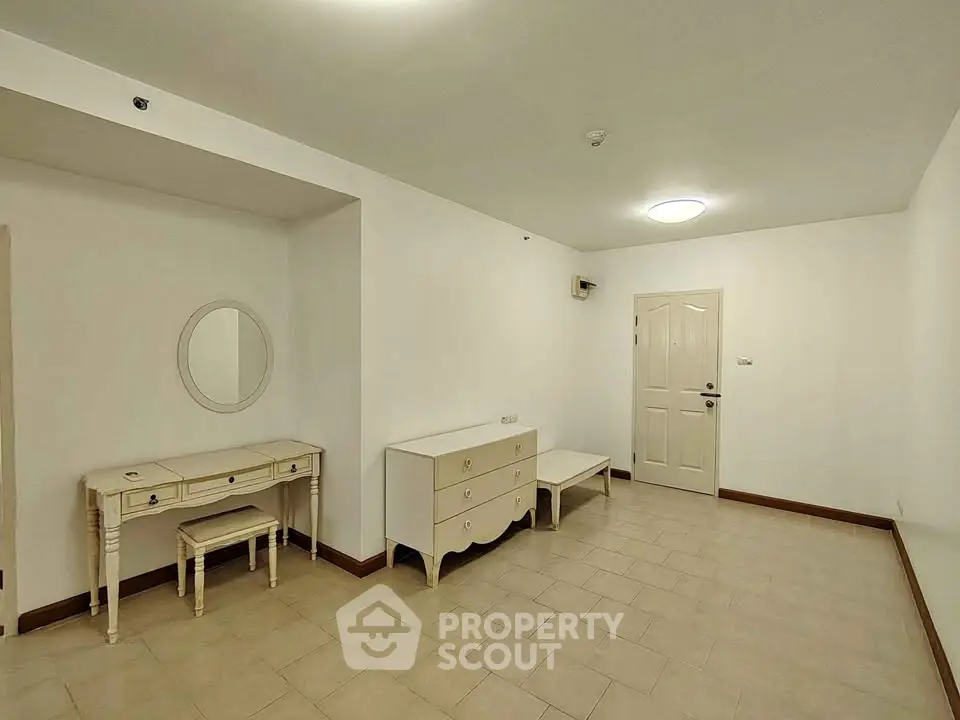 Spacious unfurnished room with tiled flooring and classic furniture, ideal for customization.