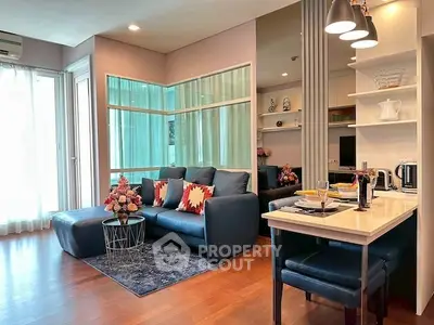 Modern living room with stylish decor and open layout, featuring a cozy seating area and dining space.