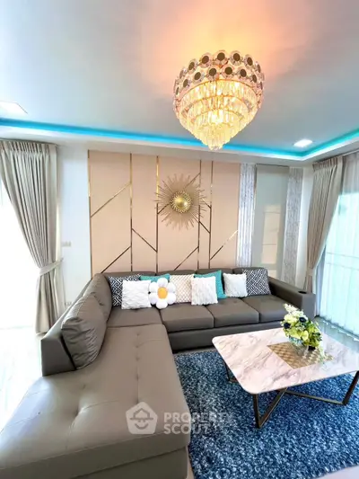 Luxurious living room with elegant chandelier and modern sectional sofa